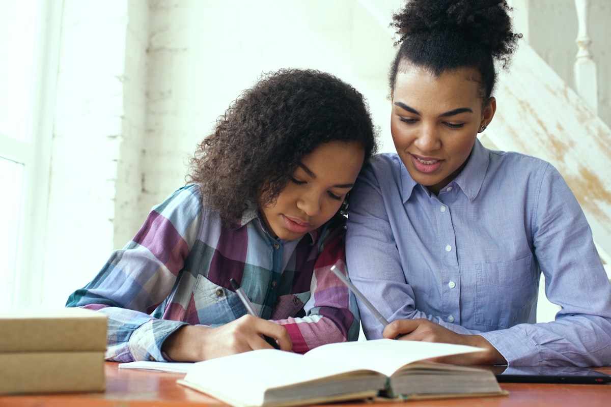 Parent helping child with spelling on a computer